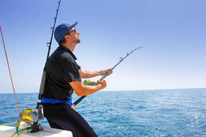 blue sea offshore fishing boat with fisherman