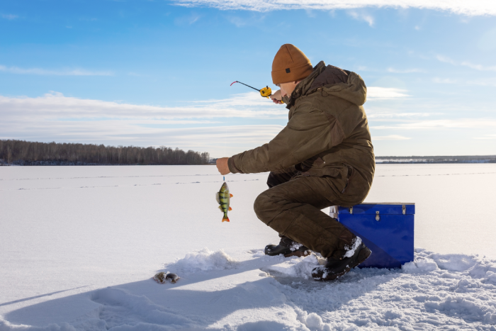 Fisherman at ice winter fishing