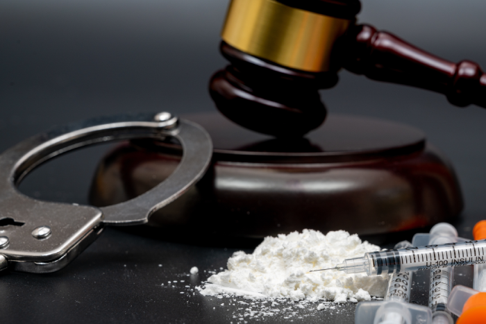 Drug crime concept with white powder and disposable syringe